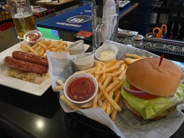 Steins signature sausages with sauerkraut alongside a juicy burger and golden fries