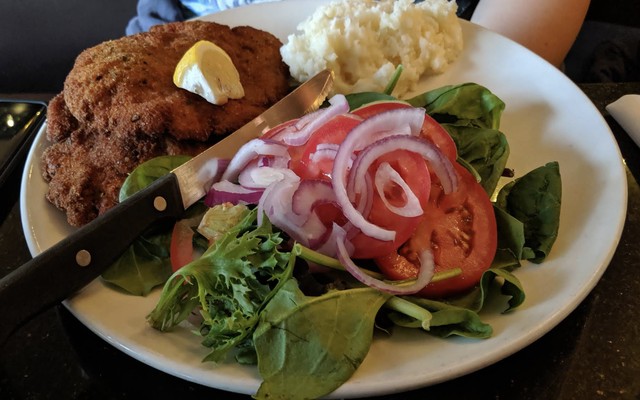 Golden wienerschnitzel with lemon on a plate